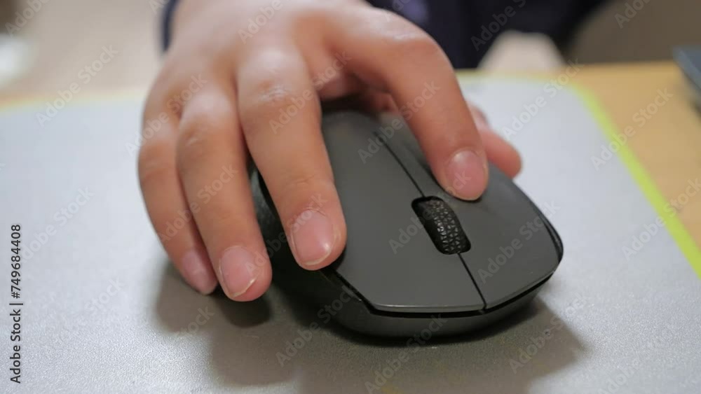 Child holds the computer mouse,child learns and plays on the computer Child holds the computer mouse,child learns and plays on the computer