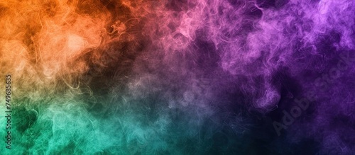 A vibrant rainbow-colored cloud of smoke billows and swirls against a stark black background. The hues of violet, green, and orange merge seamlessly to create a striking visual display.