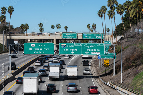 View of Los Angeles traffic and highway signs at the Hollywood 101 freeway interchange with the Pasadena and Harbor 110 freeways.