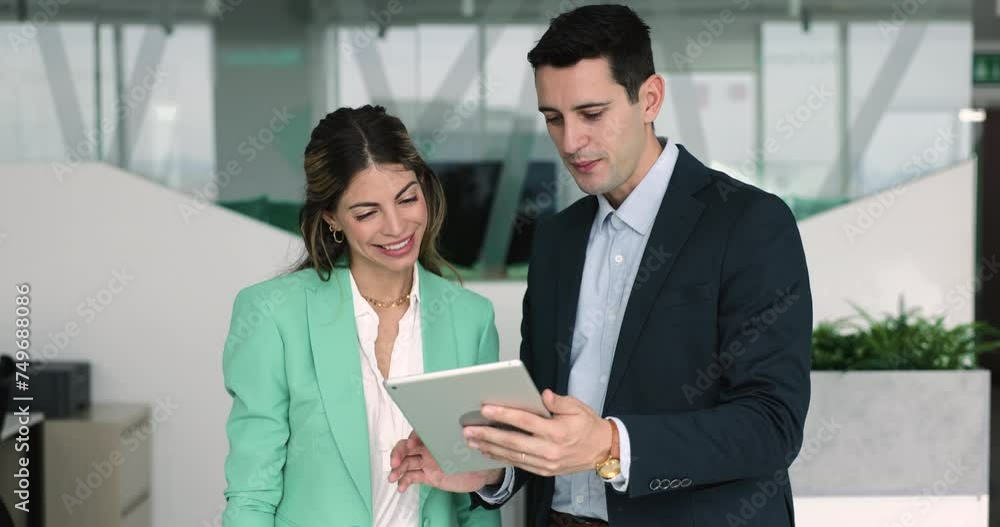 Two diverse coworkers marketing department employees discussing on-line presentation, growth strategy, review online sales on modern tablet computer, working on project together during break in office Two diverse coworkers marketing department employees discussing on-line presentation, growth strategy, review online sales on modern tablet computer, working on project together during break in office