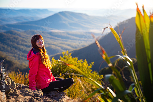 beautiful hiker girl enjoying sunset over unique, folded mountains in south east queensland, australia; main range national park near brisbane, bare rock lookout	 photo