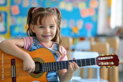 Cheerful kid playing guitar in kindergarten classroom