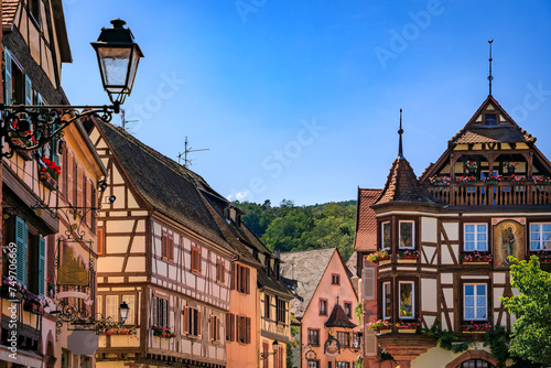 Ornate traditional half timbered houses with blooming flowers in a popular village on the Alsatian Wine Route in Kaysersberg Vignoble, France