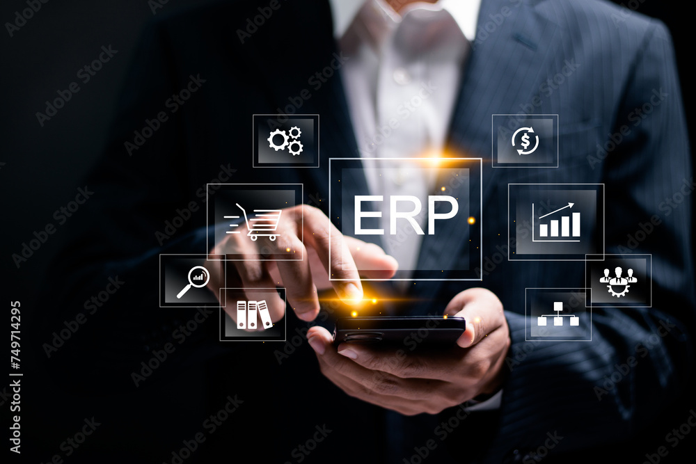 ERP, Enterprise resource planning concept. Businessman use smartphone to analyzing ERP system on virtual screen. Connections between business intelligence, HR and CRM modules. ERP, Enterprise resource planning concept. Businessman use smartphone to analyzing ERP system on virtual screen. Connections between business intelligence, HR and CRM modules.