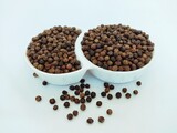 Black peppercorn seeds in a bowl blackpepper whole seed grains  hot indian spice natural food ingredient cooking masala kali mirch closeup view image stock photo