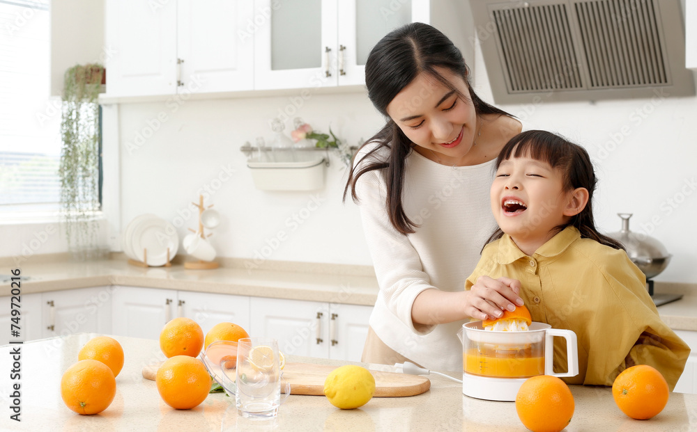 Making in the kitchen Asian mother making juice for daughter to drink