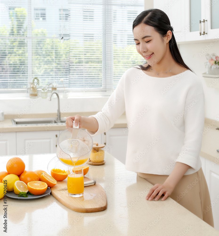 Asian girl making juice in kitchen Asian girl making juice in kitchen
