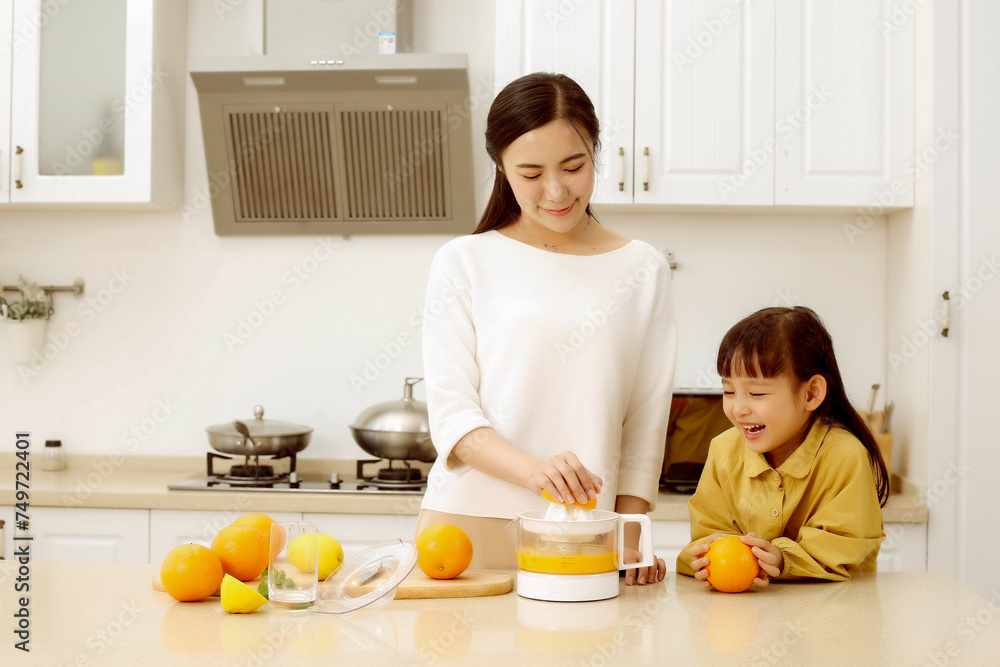 Asian mother making fresh juice with her daughter