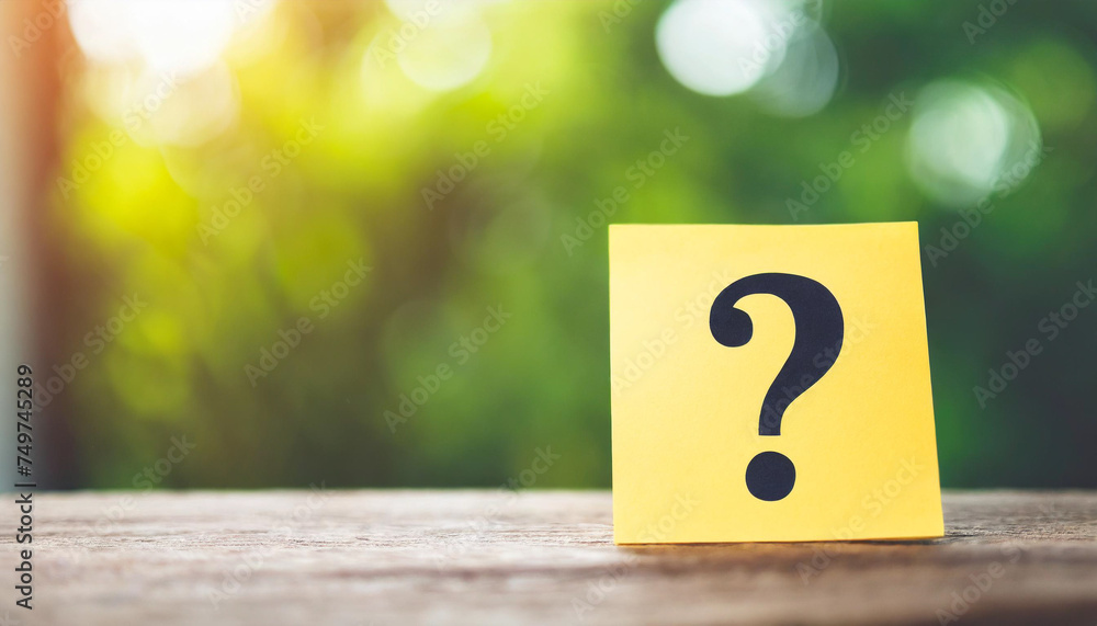 Panoramic stock photo featuring note paper with a question mark symbol on a clean background Panoramic stock photo featuring note paper with a question mark symbol on a clean background