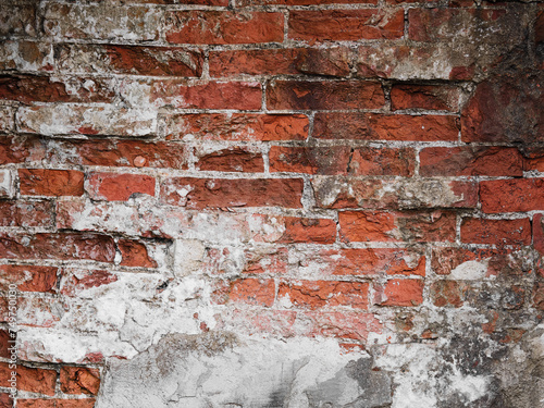 Old wall background with bricks and damaged plaster