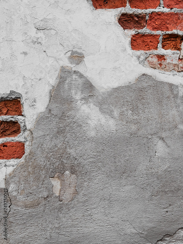 Old wall background with bricks and damaged plaster