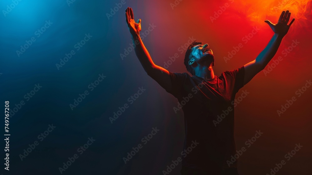 A Christian man praying to God crying and emotional with his arms raised