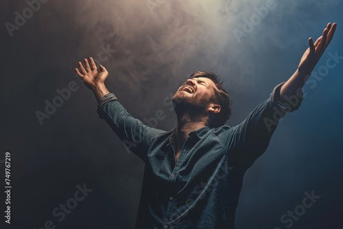 Obraz na płótnie A Christian man praying to God crying and emotional with his arms raised w salonie