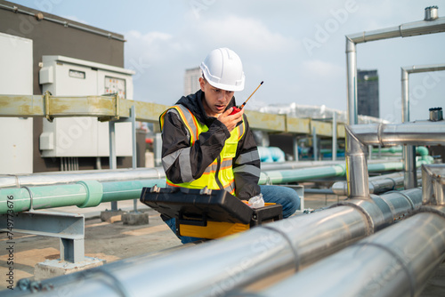 Technician Using Measuring Equipment on Industrial Pipes