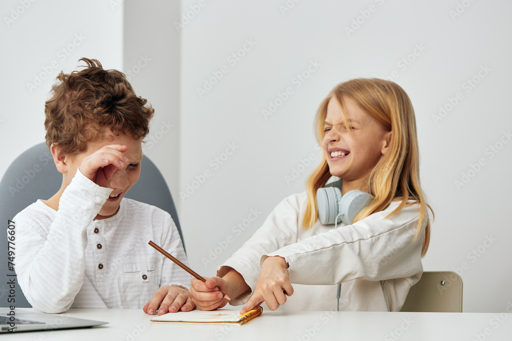Happy Boy and Girl Studying Online with Laptops at Home Happy Boy and Girl Studying Online with Laptops at Home