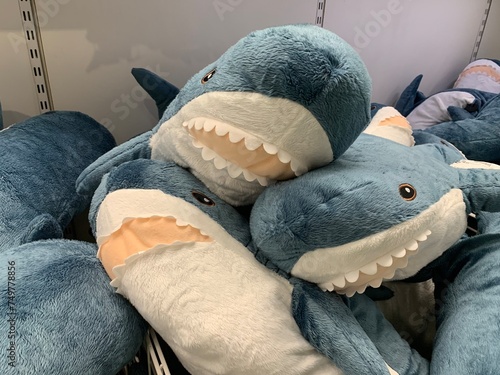 Shop display full of blue and white stuffed animal sharks