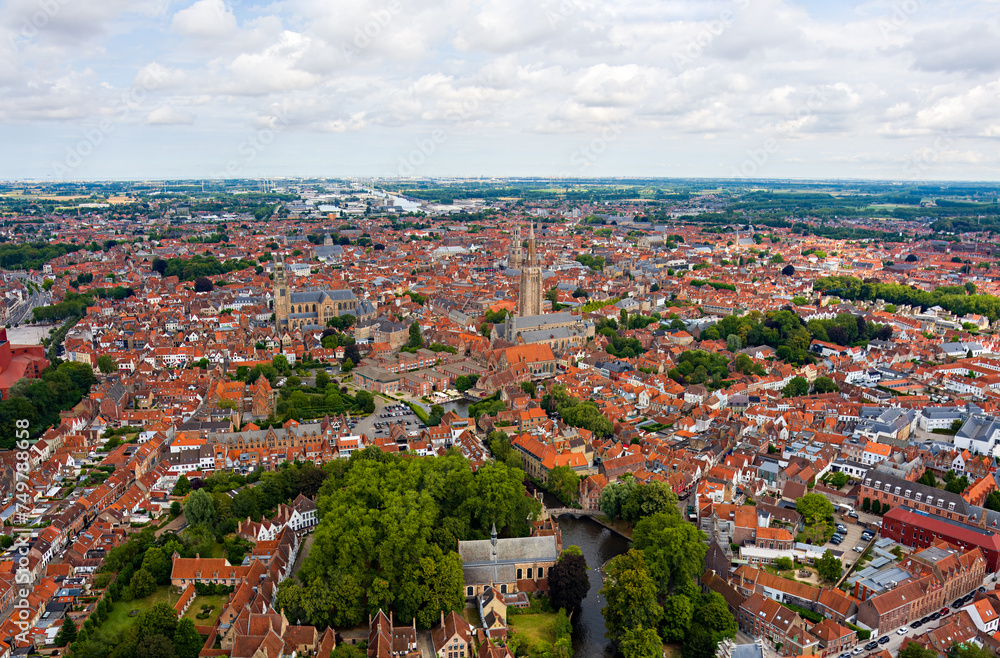 Bruges, Belgium. City center. Residential areas. Panorama of the city. Summer day, cloudy weather. Aerial view