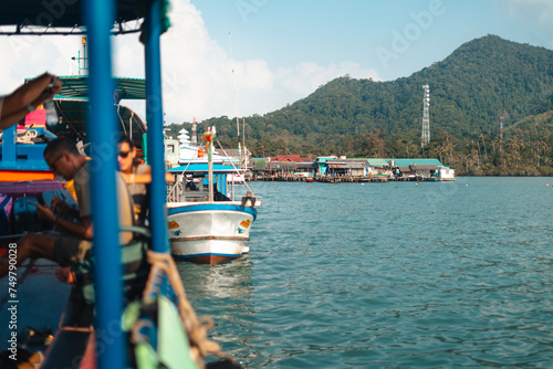 Seaside Boats: A picturesque view of boats in the harbor and on the river, surrounded by the sea, under a summer sky The old pier, dock, and coastal landscape complete this charming maritime scene photo