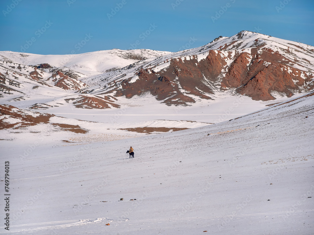 Horseman on a snow-white snowy mountain slope.