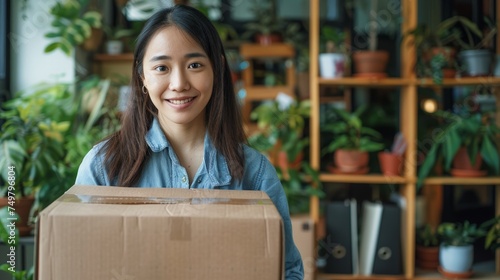 Startup small business entrepreneur SME, asian woman packing box. Portrait of young Asian small business owner in home office, © chanidapa
