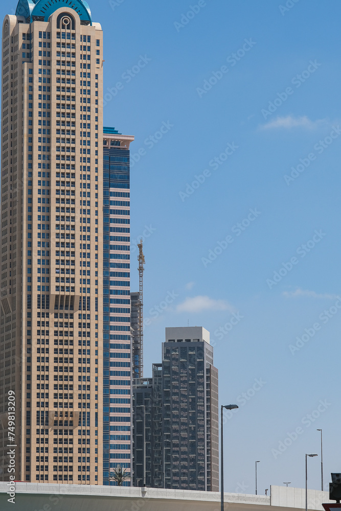Futuristic and modern commercial and residential highrise tower skyscraper architecture with glass facades and clean lines in downtown Dubai, United Arab Emirates for millionaires and high society Futuristic and modern commercial and residential highrise tower skyscraper architecture with glass facades and clean lines in downtown Dubai, United Arab Emirates for millionaires and high society