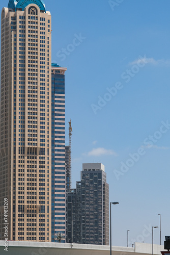 Futuristic and modern commercial and residential highrise tower skyscraper architecture with glass facades and clean lines in downtown Dubai  United Arab Emirates for millionaires and high society