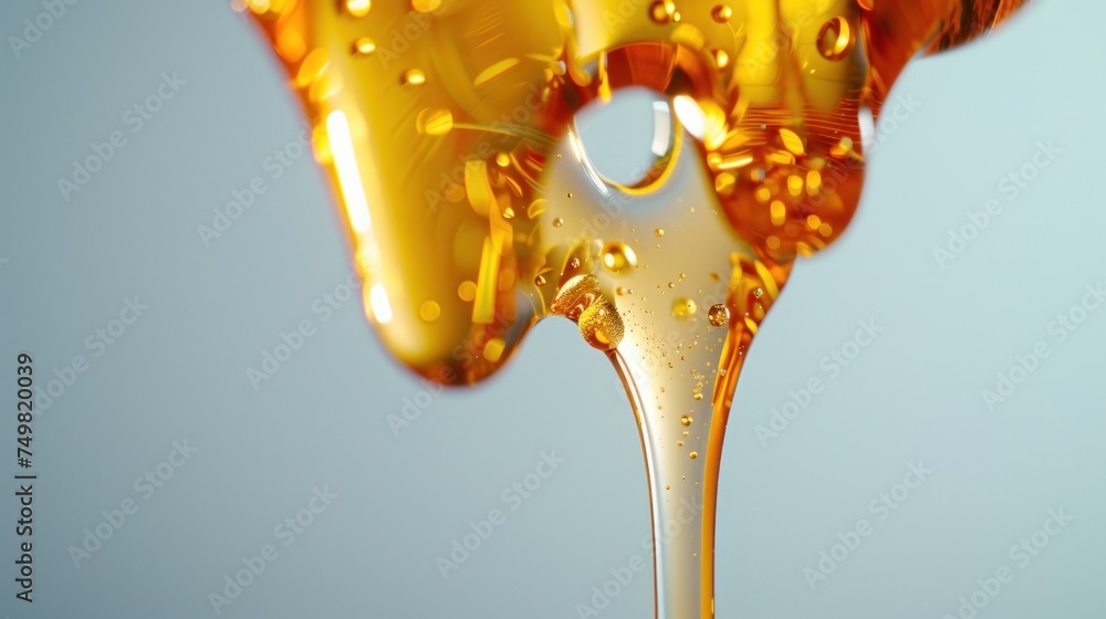 Naklejka premium Golden honey pouring from spoon with honey drops and flow, detailed close-up view on neutral background. Natural sweetener and healthy food ingredient.