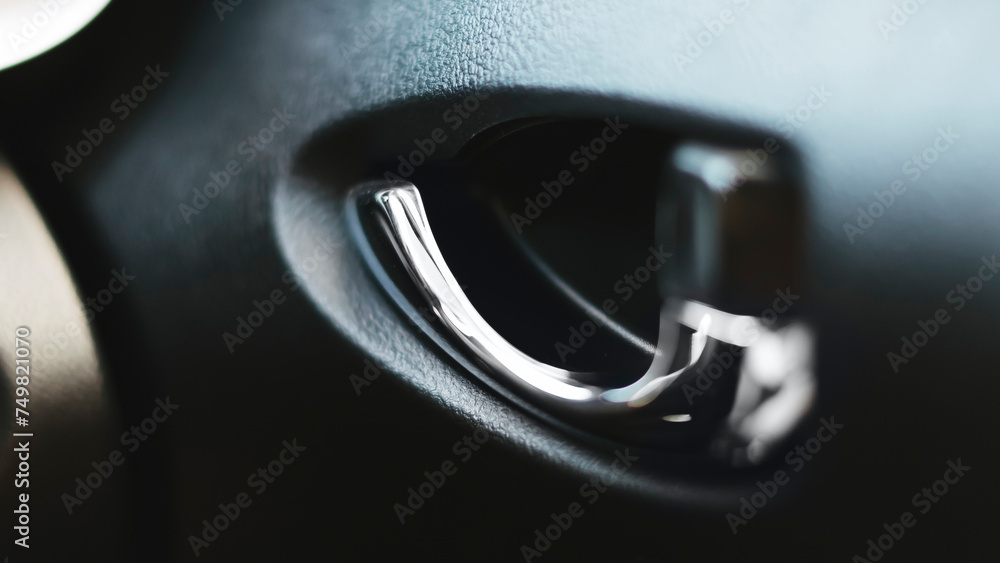 Closeup metallic Car door opener handle inside a modern Car. Selective focus.