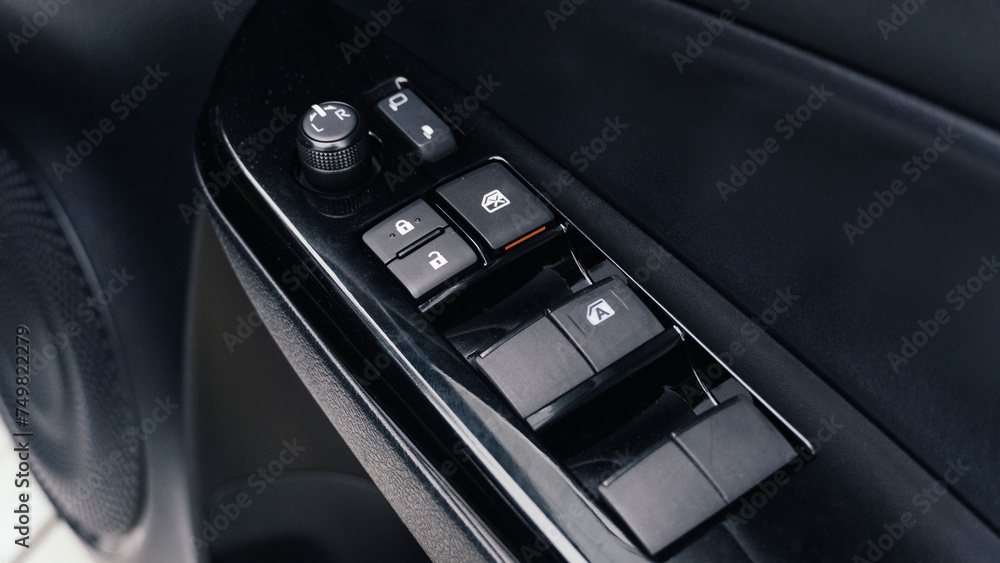 Interior of modern car. Side door buttons: window, mirror adjustment buttons, door lock. Car inside.