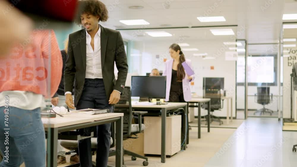 Coworkers standing up and leaving the office Coworkers standing up and leaving the office