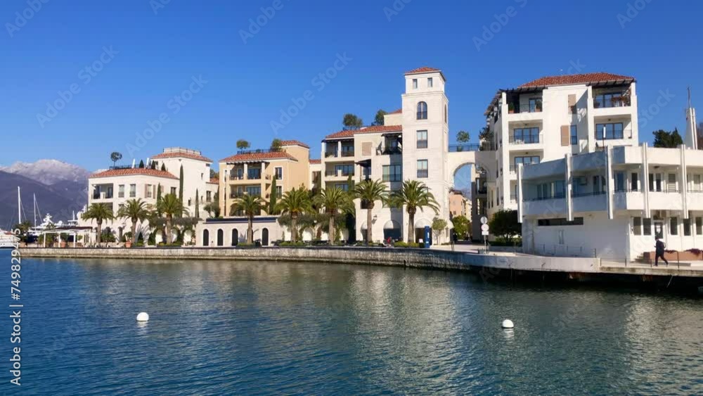 Waterfront promenade with ocean and mountain views. Bay of Kotor. Luxury living in the seaside town of Porto Montenegro, Tivat, Montenegro. Europe. Waterfront promenade with ocean and mountain views. Bay of Kotor. Luxury living in the seaside town of Porto Montenegro, Tivat, Montenegro. Europe.