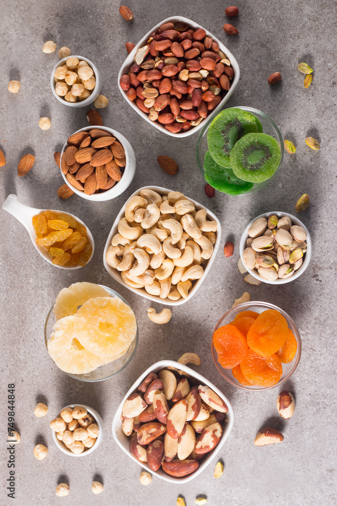 Healthy mix nuts and dried fruits on wooden background. Almonds, hazelnuts, cashews, peanuts, pistachios, Brazilian nuts Healthy mix nuts and dried fruits on wooden background. Almonds, hazelnuts, cashews, peanuts, pistachios, Brazilian nuts