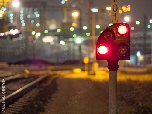 Red railroad signal in the night