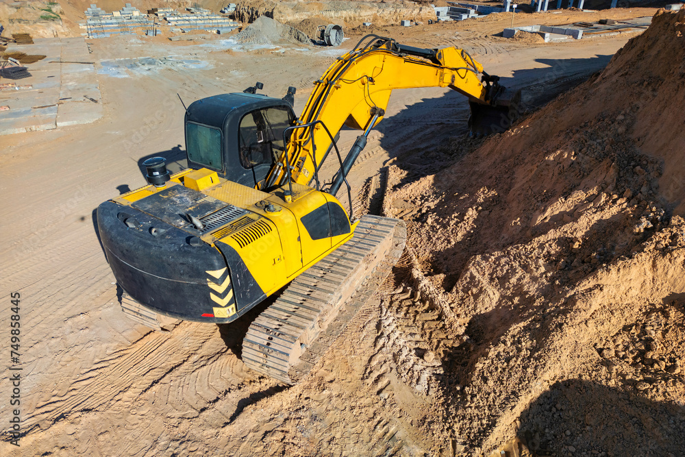 A yellow bulldozer actively excavating soil on a construction site, preparing the ground for future development A yellow bulldozer actively excavating soil on a construction site, preparing the ground for future development