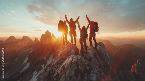 Climbers celebrating summit ascent. Team jubilant against mountain backdrop at sunset, conveying triumph.