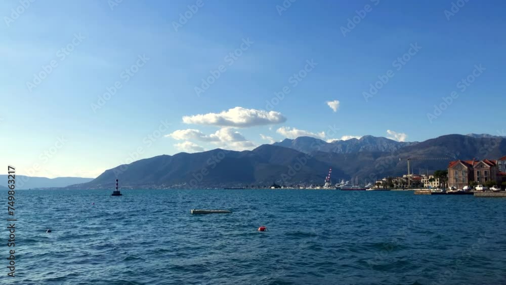 Coastal town with ocean views and mountains in the background. Bay of Kotor. Adriatic Sea. Porto Montenegro, Tivat, Montenegro. Europe. Coastal town with ocean views and mountains in the background. Bay of Kotor. Adriatic Sea. Porto Montenegro, Tivat, Montenegro. Europe.