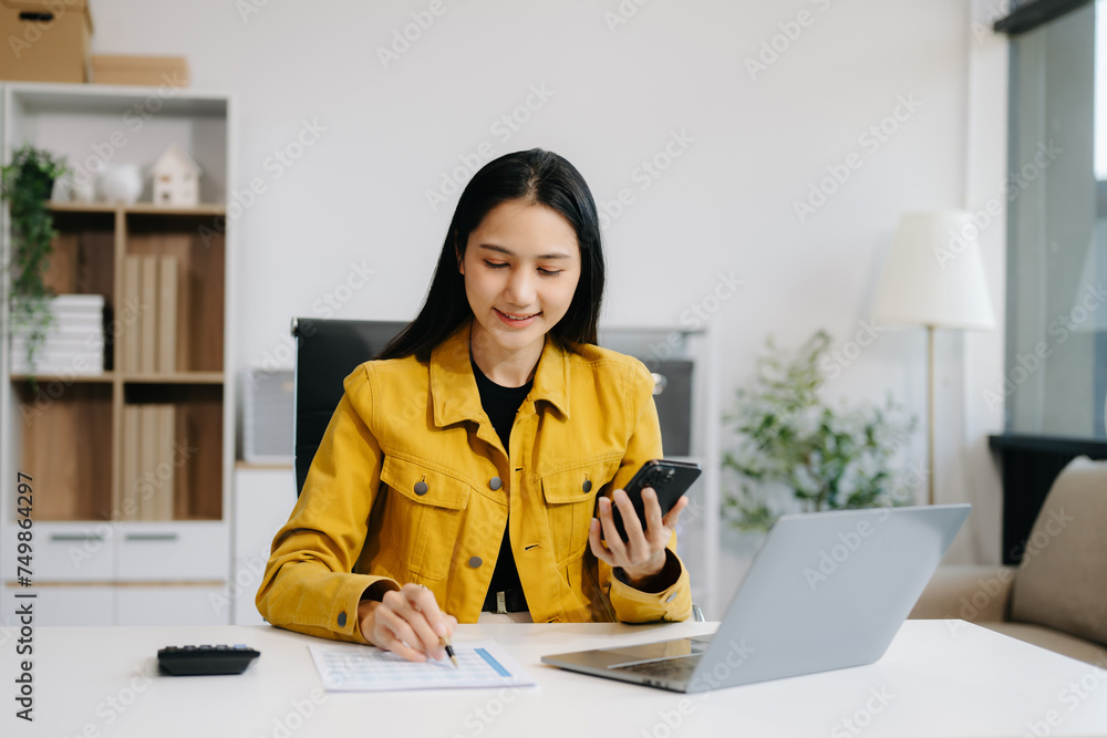 Asian Businesswoman Analyzing Finance on Tablet and Laptop at modern Office Desk tax Asian Businesswoman Analyzing Finance on Tablet and Laptop at modern Office Desk tax