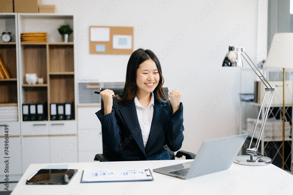 Asian business woman are delighted and happy with the work they do on their tablet, laptop and taking notes . Asian business woman are delighted and happy with the work they do on their tablet, laptop and taking notes .