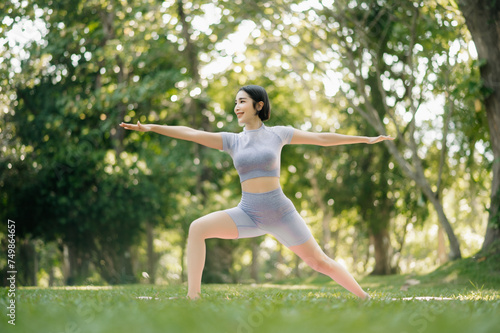 Portrait of young woman practicing yoga in garden.female happiness. in the park blurred background.