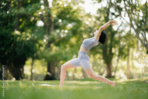 Portrait of young woman practicing yoga in garden.female happiness. in the park blurred background.