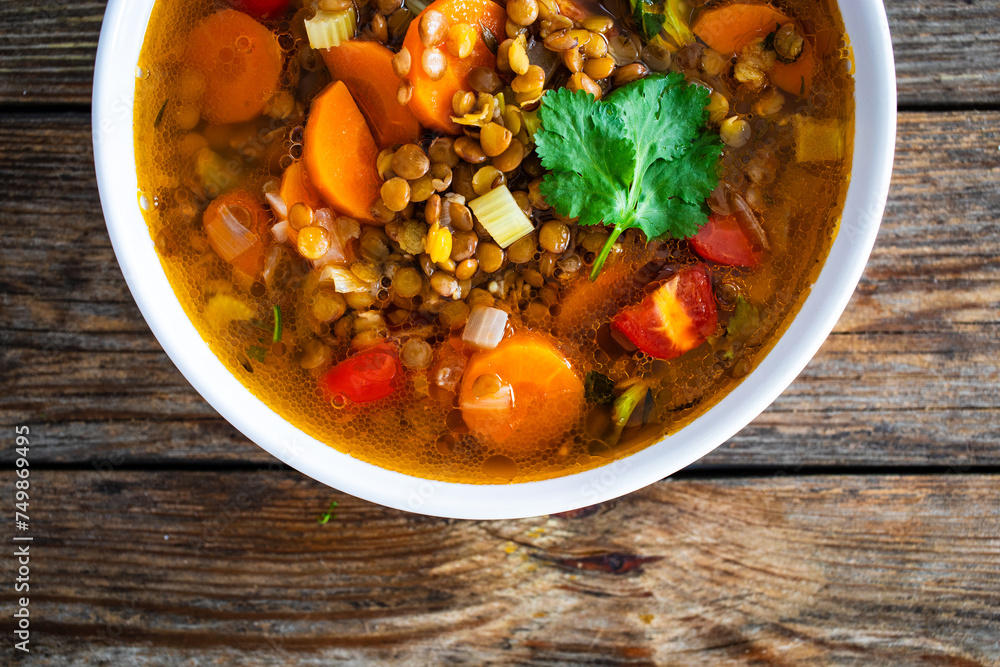 Fresh vegetable soup with lentil on wooden table
Fresh vegetable soup with lentil on wooden table