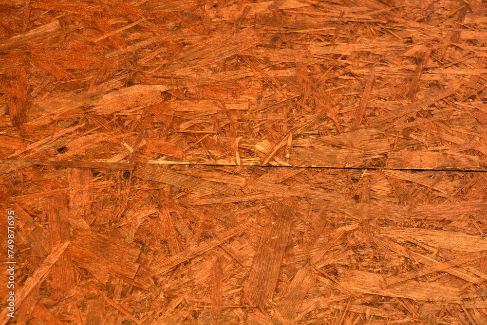 Construction oriented chipboard covered with brown varnish, original woody background plate.