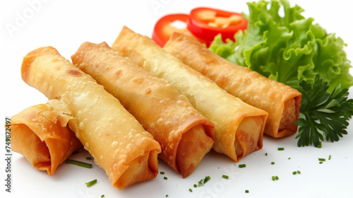 Chinese spring rolls  golden and crispy  served with lettuce  parsley  and slices of red pepper  on a white background  studio food photography for design and print