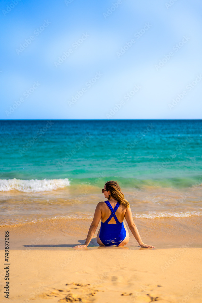 Beautiful woman sitting and sunbathing on the beach Santa Maria, Cape Verde, Sal Island
Beautiful woman sitting and sunbathing on the beach Santa Maria, Cape Verde, Sal Island