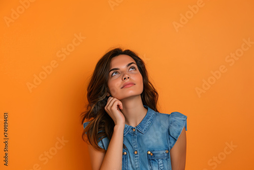 A woman with long hair is looking up at the ceiling