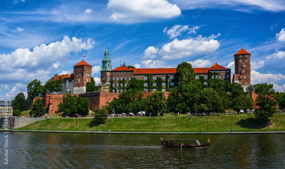 Front view of Wawel castle in Krakow, Poland with boats on Vistula river at summer time.