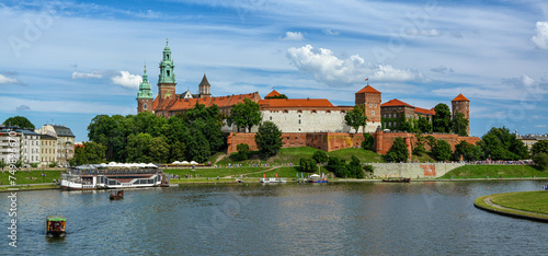 Front view of Wawel castle in Krakow, Poland with boats on Vistula river at summer time. photo