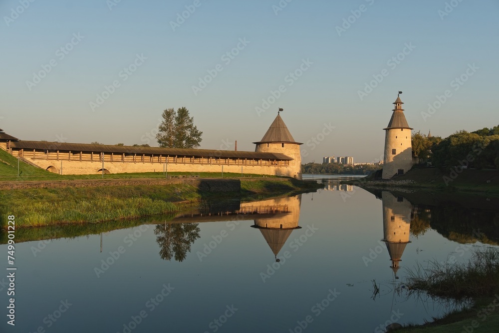  Pskov, Russia, September 11, 2023. Reflection in the water of the fortress towers at dawn.                              