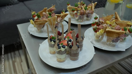 Assorted Canapes and Parfait Desserts on White Plates Ready for Serving at an Elegant Event