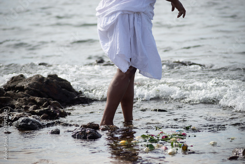 Members of Candomble are seen on the beach throwing gifts to Iemanja on Rio Vermelho beach, in the city of Salvador, Bahia. photo